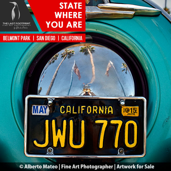 REFLECTION ON THE SPARE WHEEL COVER OF A CLASSIC MERCURY CAR.