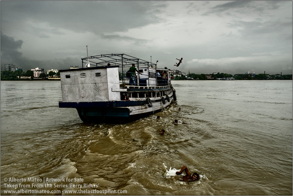 Boys swimming back to the docks, Hooghly River, Kolkata, India.