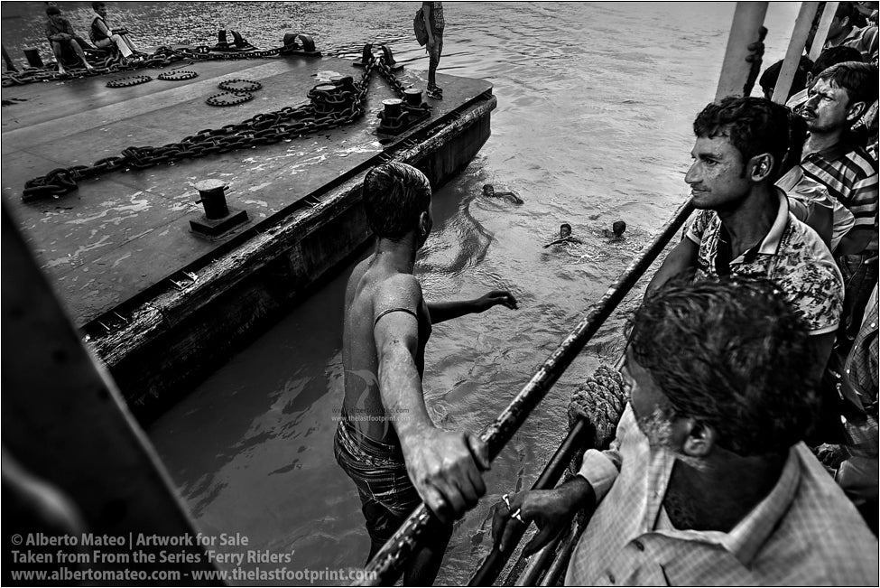 Boys on ship gunwale, Kolkata, India.