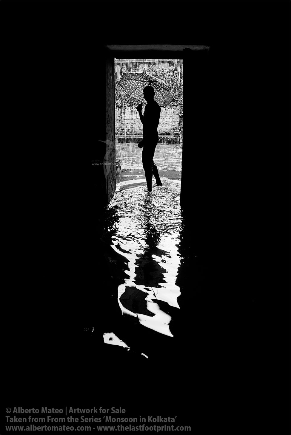 Man getting out of his home under the rain, Shibpur, Kolkata, Bengal, India.