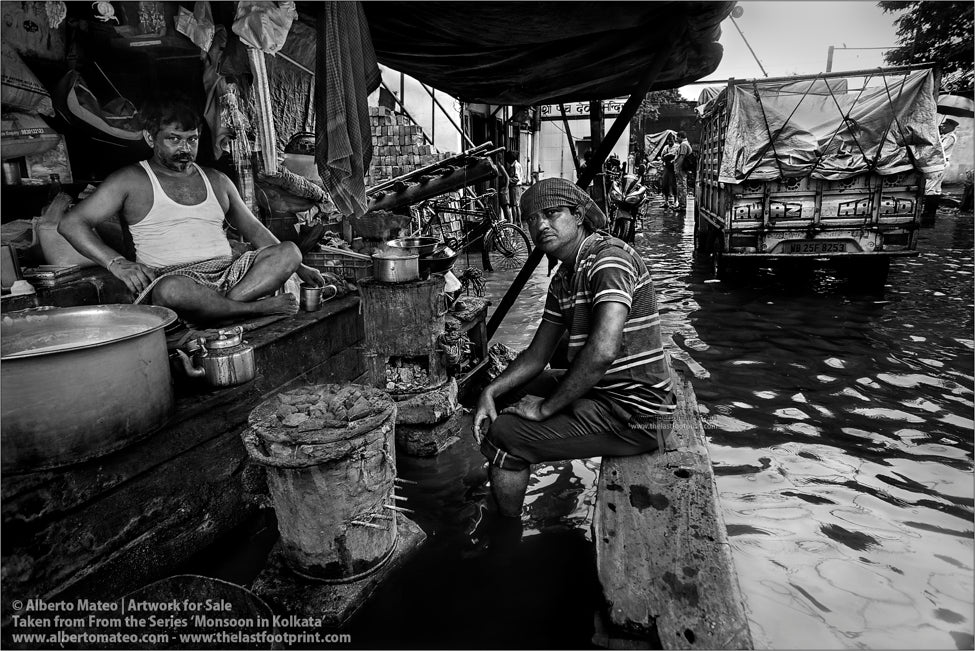 Porter having a chai under Monsoon rain, Shibpur, Kolkata, Bengal, India.