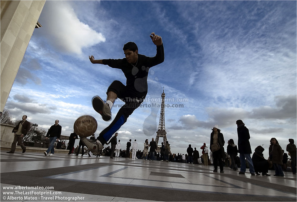 Boy playing soccer at Trocadero, Paris, France.