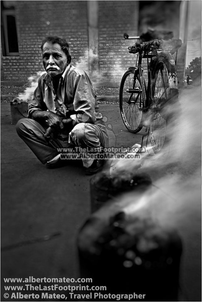 Portrait of man next to cooking stoves, Chandigarh, Haryana, India.