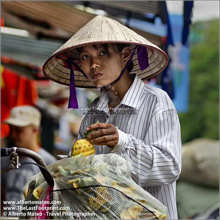 Girl selling pineapples, Hanoi, Vietnam. | Square crop.