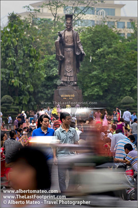 Dense traffic under Li Thai To sculpture, Hanoi, Vietnam.