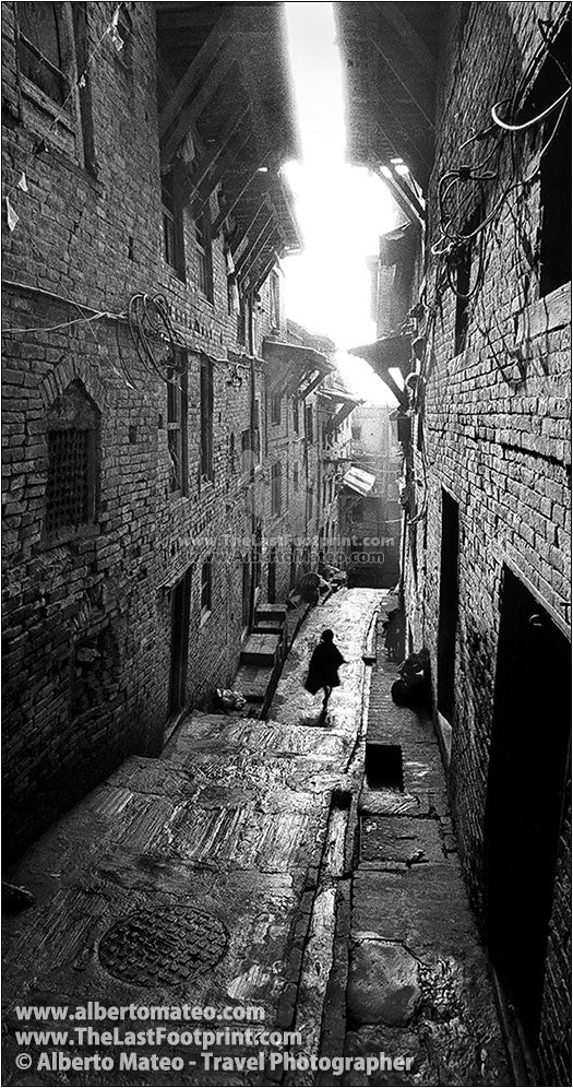 Boy running in Bhaktapur old quarters, Kathmandu, Nepal.