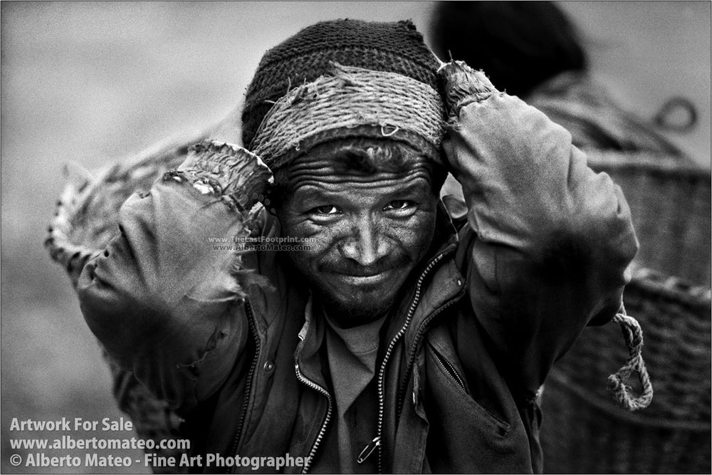 Porter carrying stones, Himalaya. | Black and White Portrait Print.