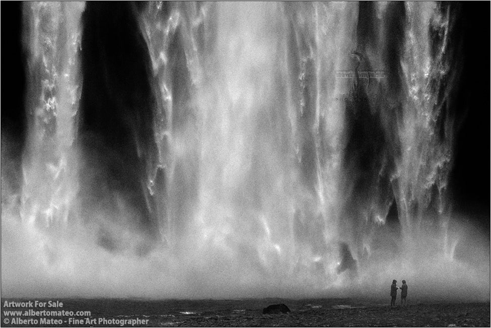 Couple under Skogafoss, Skogar, Iceland.