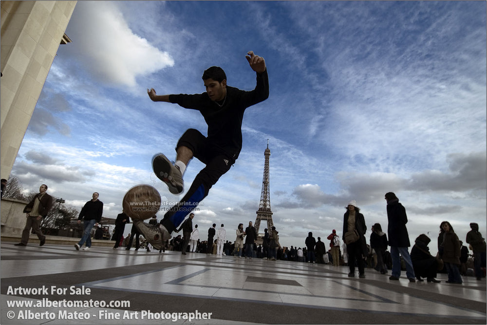 Boys playing soccer near Eiffel Tower, Paris, France. | By Alberto Mateo.