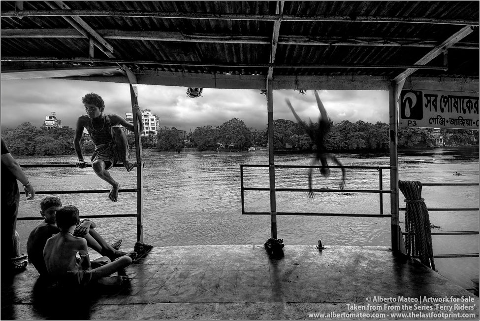 Passengers chatting on Ferry and boy diving in the distance, Kolkata, India.