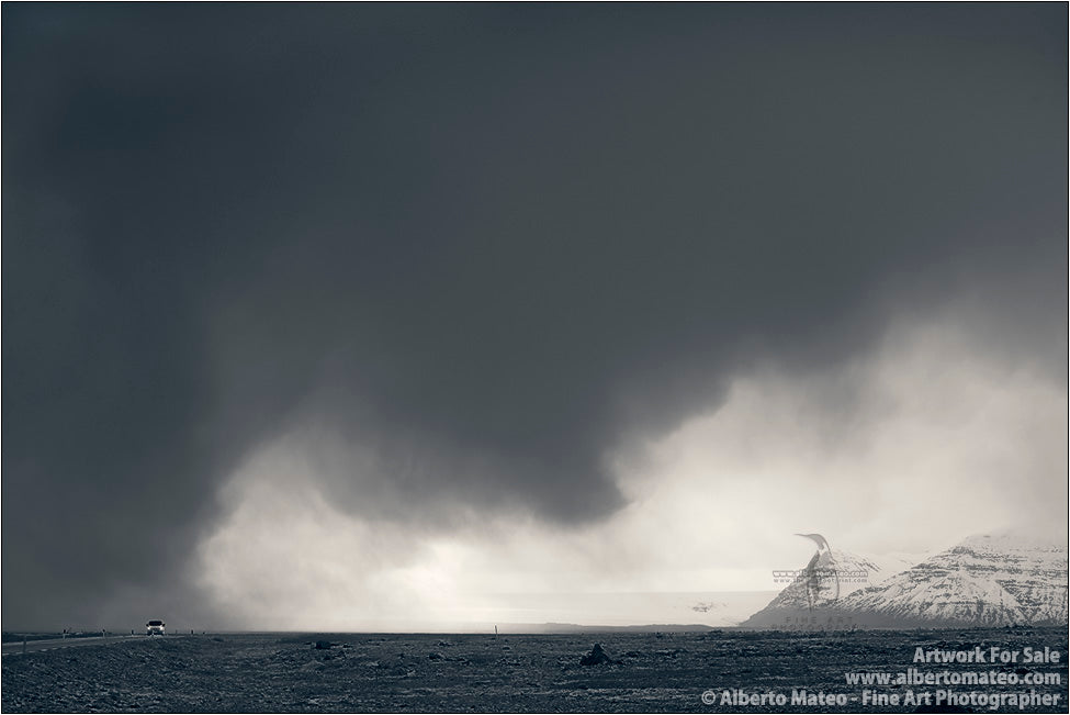 Car under storm clouds, Iceland.