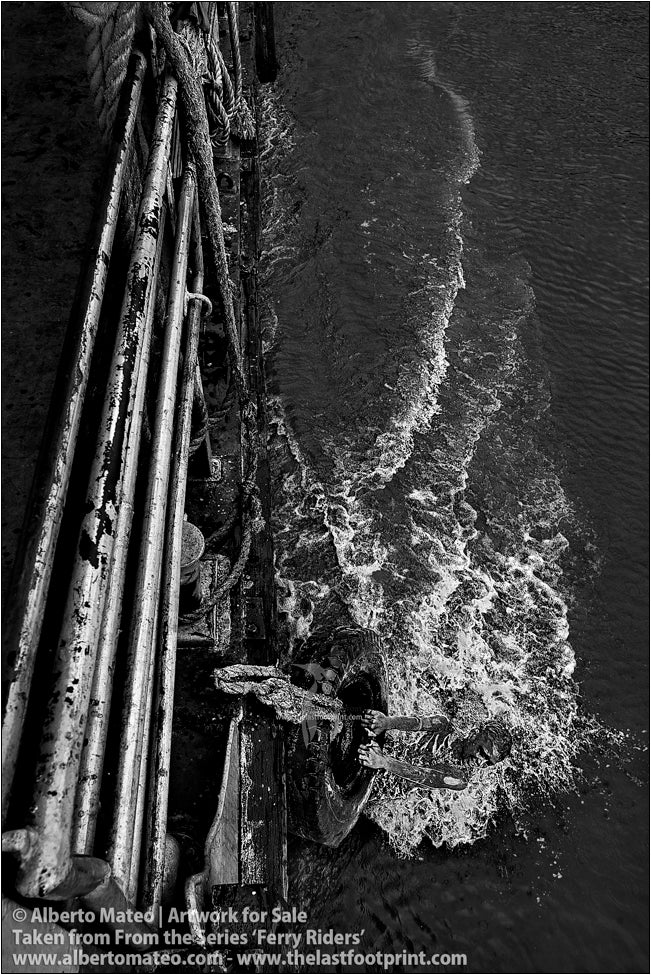 Boy on water dragged by a ship, Kolkata, India.