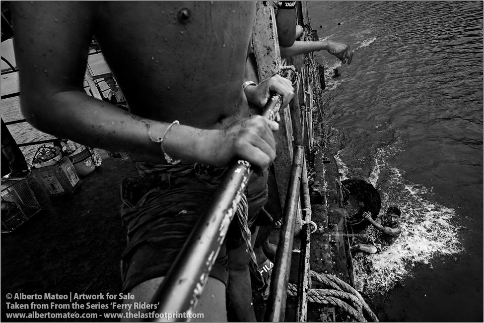 Boys on water dragged by a ship, Kolkata, India.