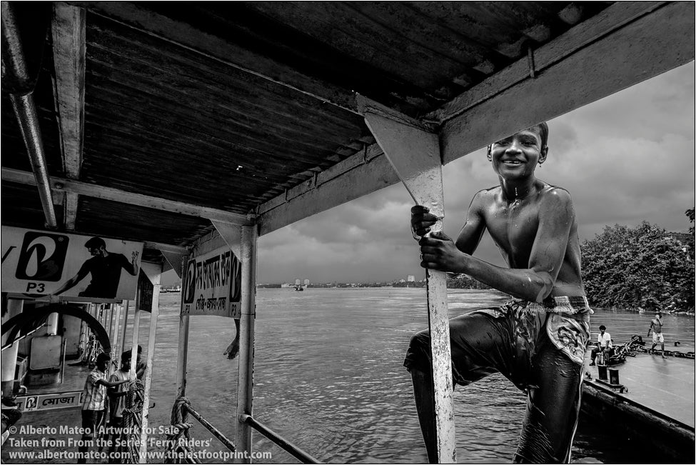 Boy climbing to the roof of a ship, Kolkata, India.