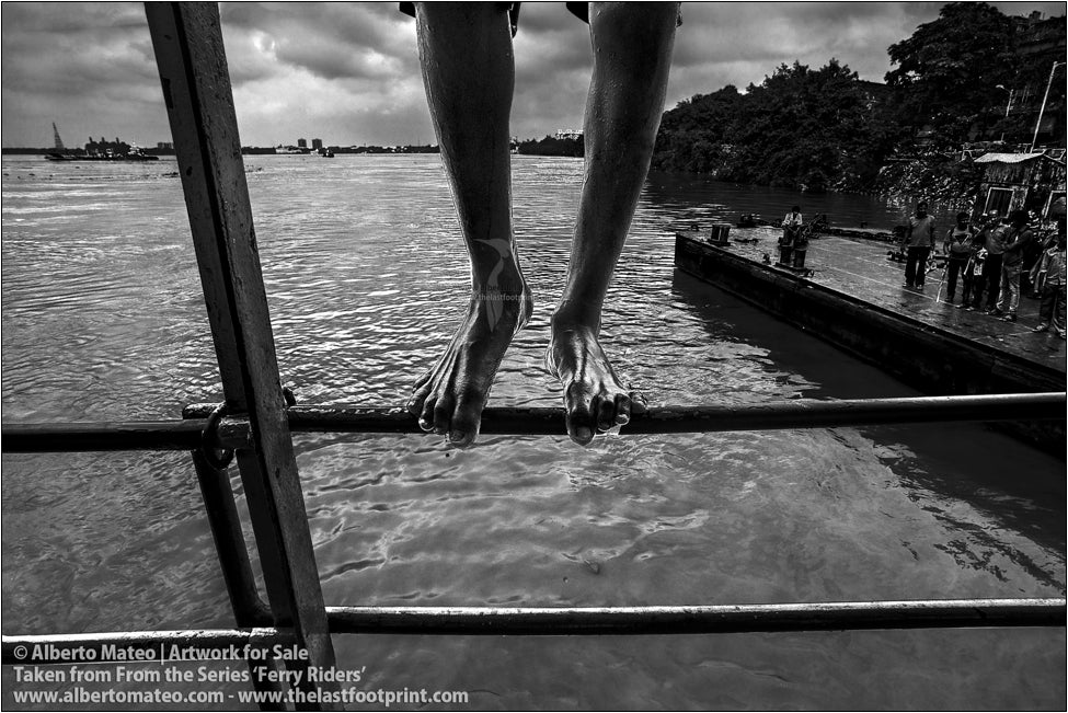 Feet of a boy climbing to the roof of a ship, Kolkata, India.