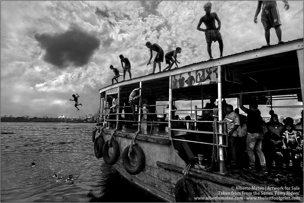 Ferry riders diving from the roof of a ship, Kolkata, India.