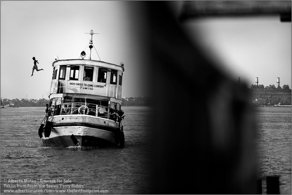 Boy jumping from ferry roof, Kolkata, India.