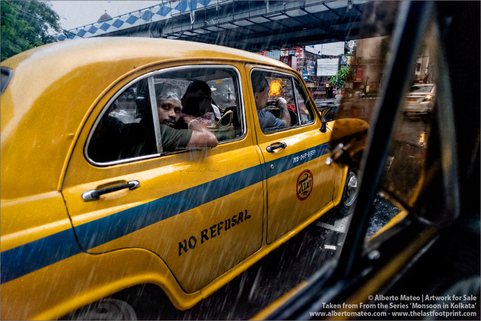 Loaded Taxi under the rain, Kolkata, Bengal, India.