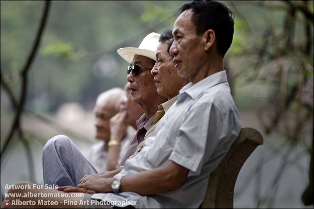 Four men next to Hoan Kiem Lake, Hanoi, Vietnam.