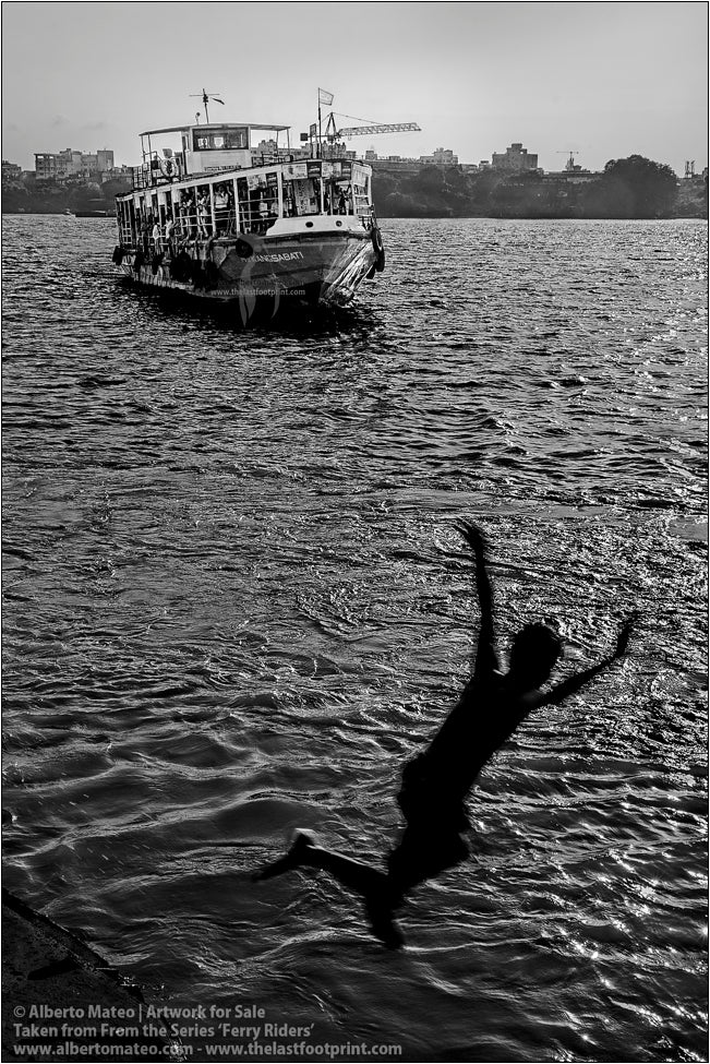 Boy diving in river, Kolkata, India.