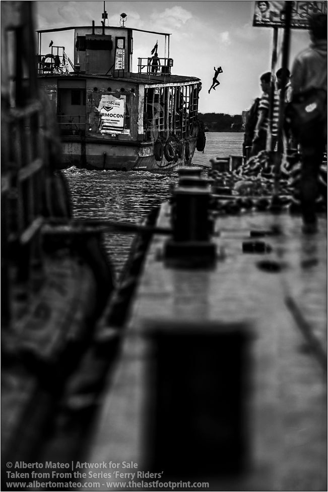 Boy jumping from ship, Kolkata, India.