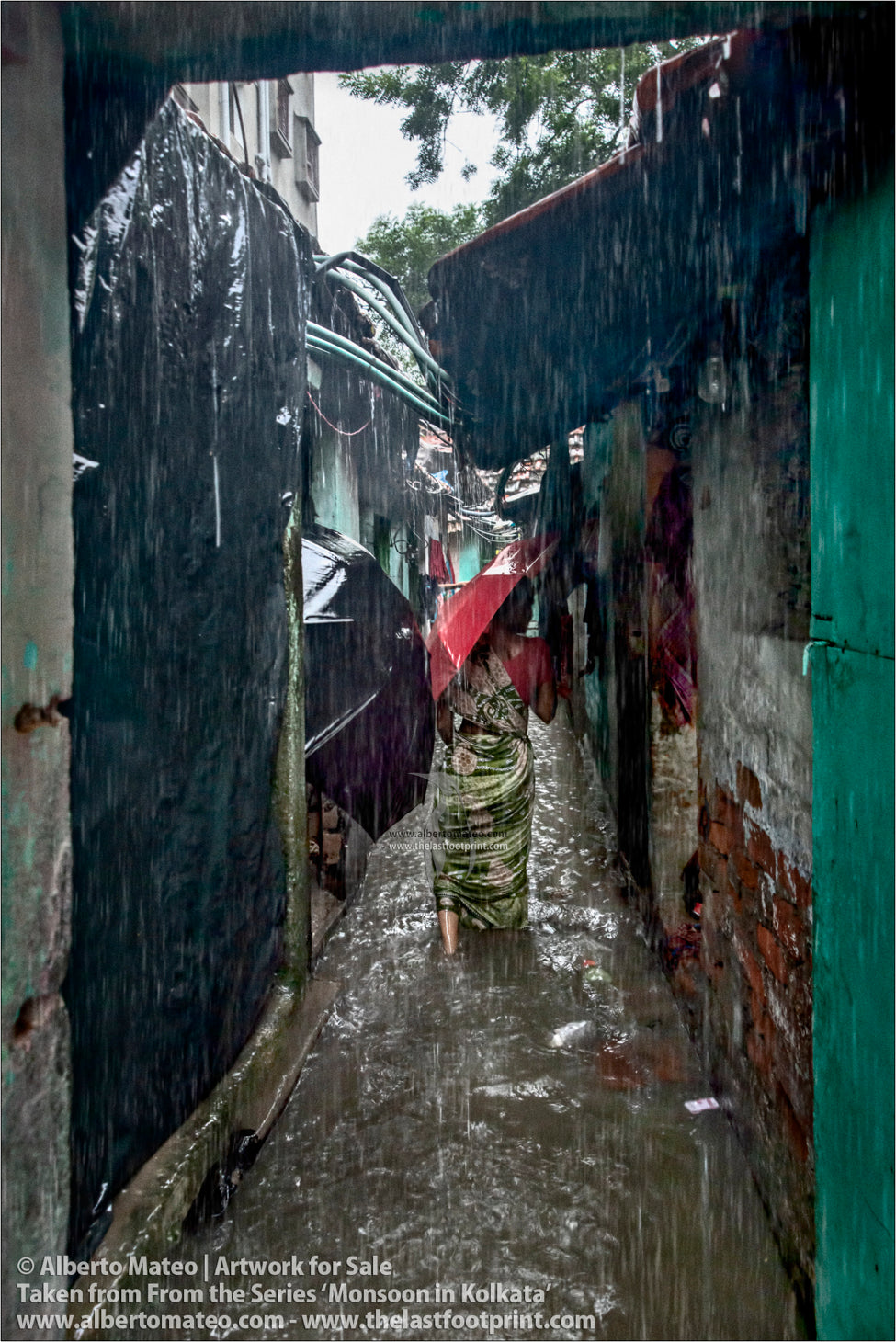 Woman entering her house under the rain, Shibpur, Kolkata, Bengal, India.