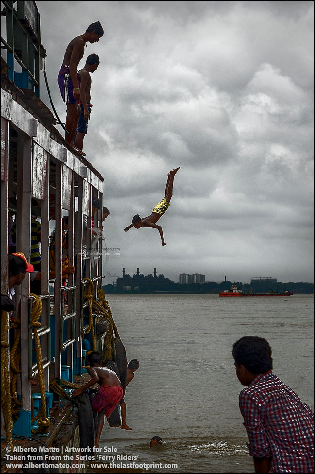 Boy jumping from roof of ship, Hooghly River, Kolkata, India.