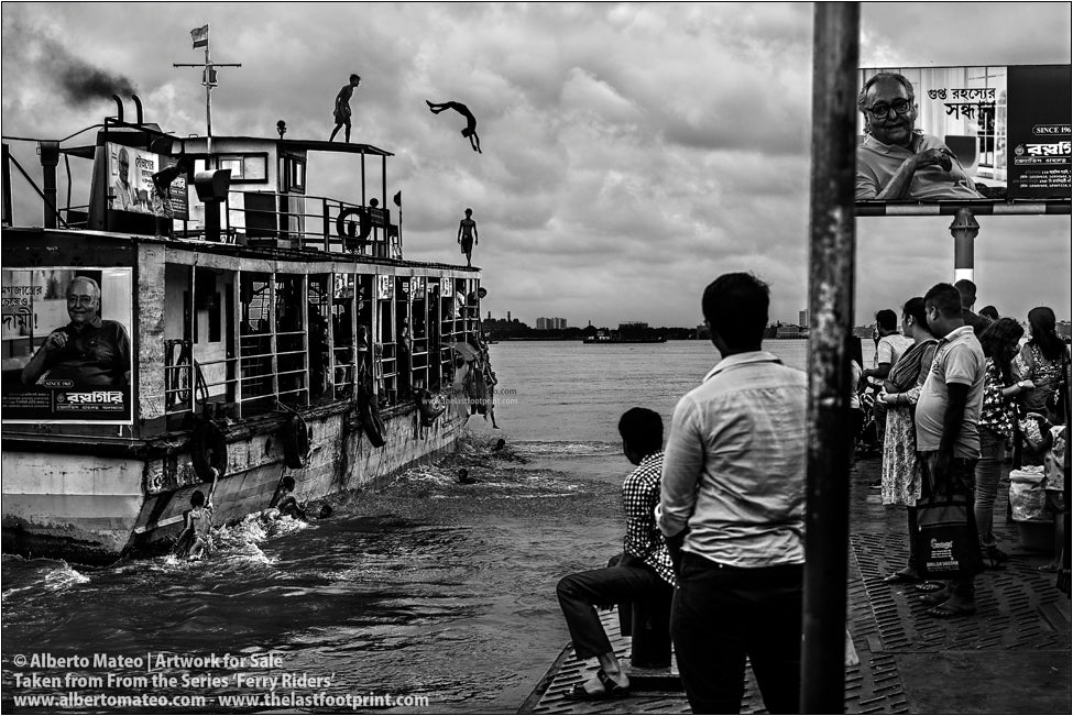 Boys diving from roof of ship, Hooghly River, Kolkata, India.