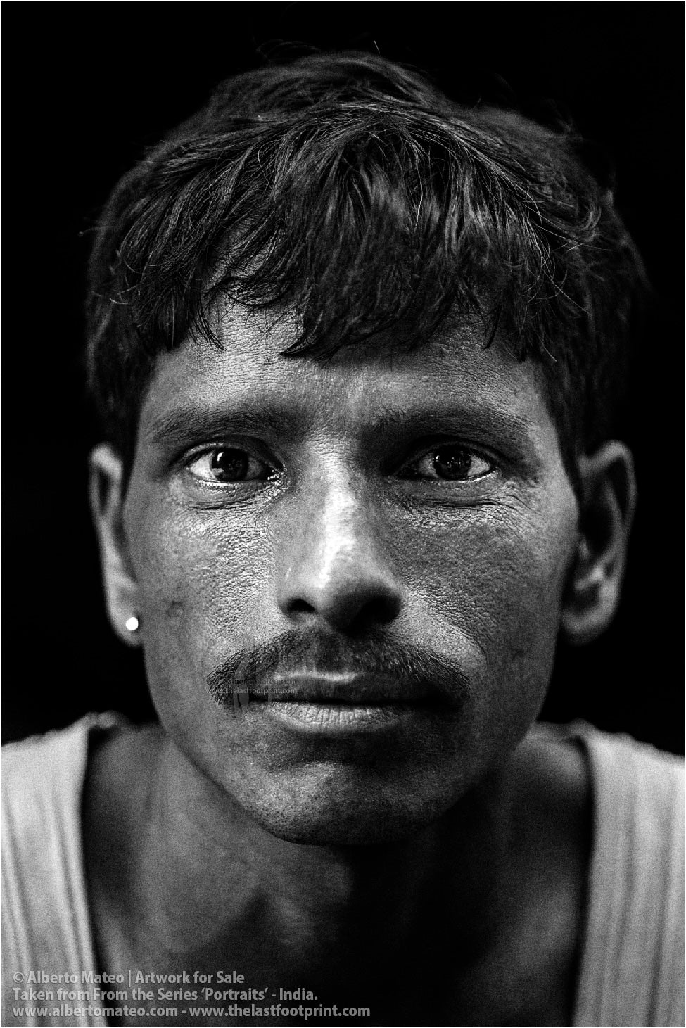 Portrait of young Porter in Bara Bazar streets, Kolkata, India.