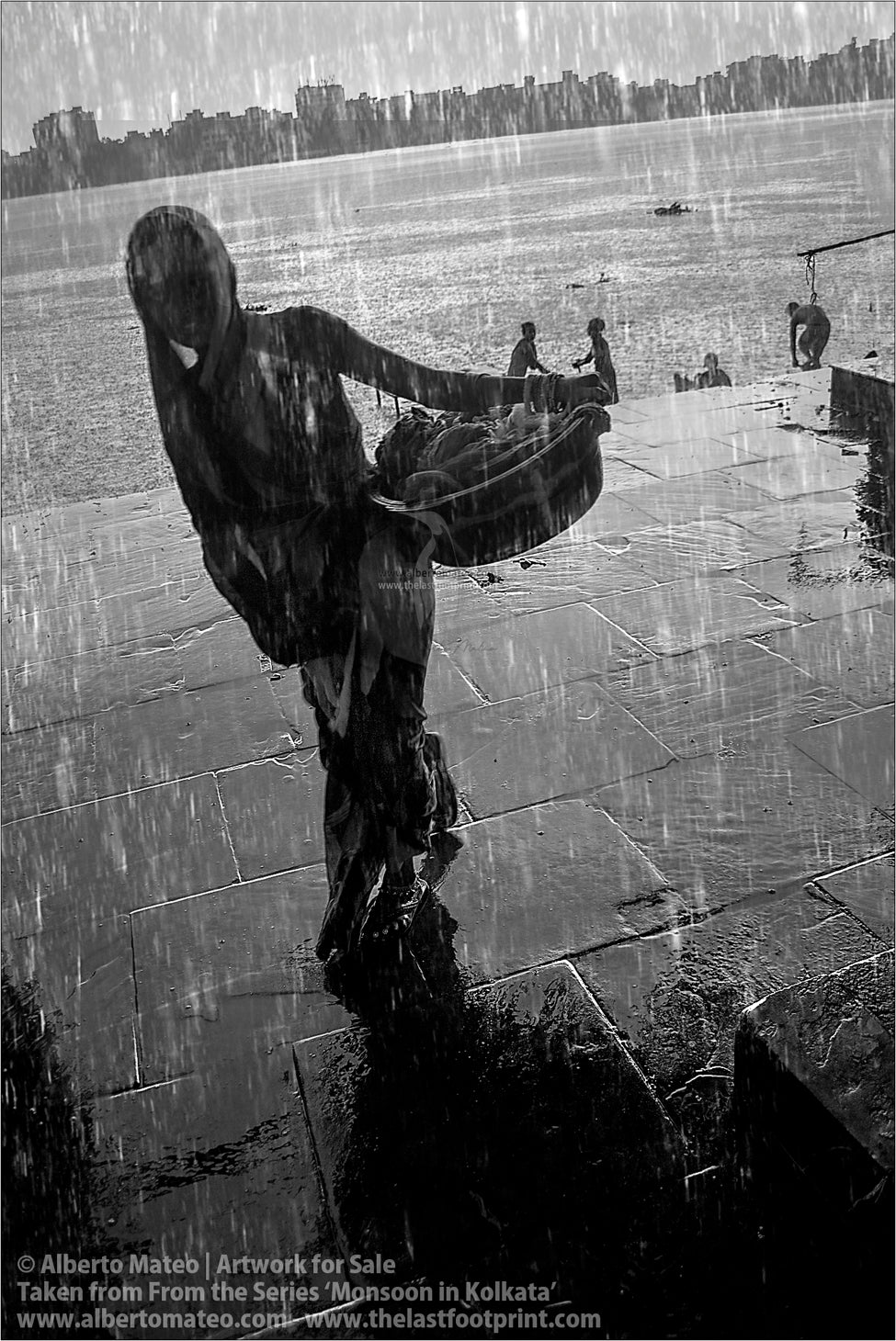 Woman with laundry under the rain, Bara Bazar, Kolkata, Bengal, India.