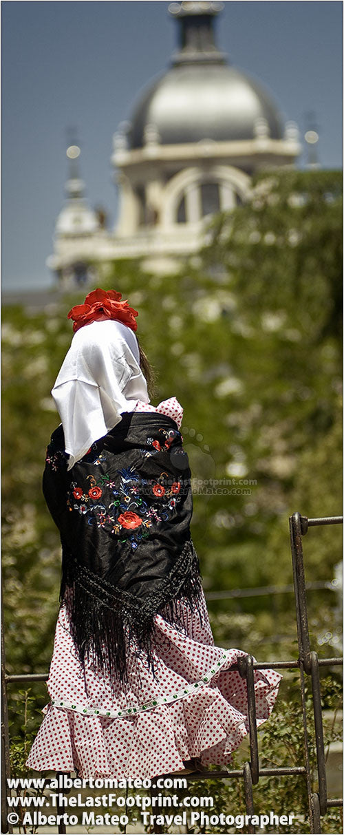Girl dressed as 'Chulapa' under La Almudena Cathedral, Madrid, Spain.