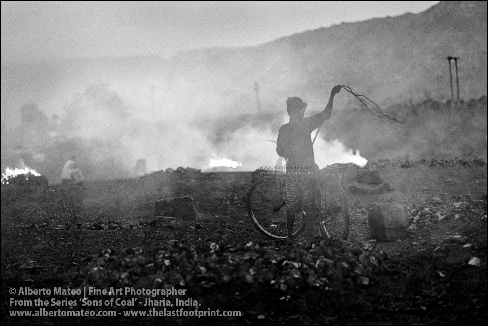 Boy tying Coal Bags on Bicycle, Sons of Coal Series.